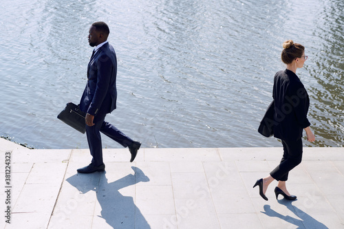 Contemporary business people in formalwear passing by each other by eiverside