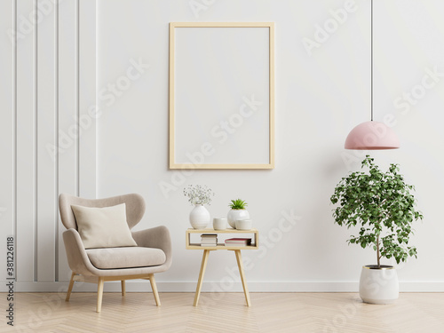 Poster mockup with vertical frames on empty white wall in living room interior with blue velvet armchair.