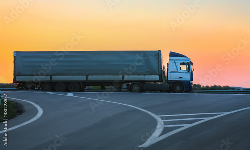 Truck goes on highway on sunset © Yuri Bizgaimer