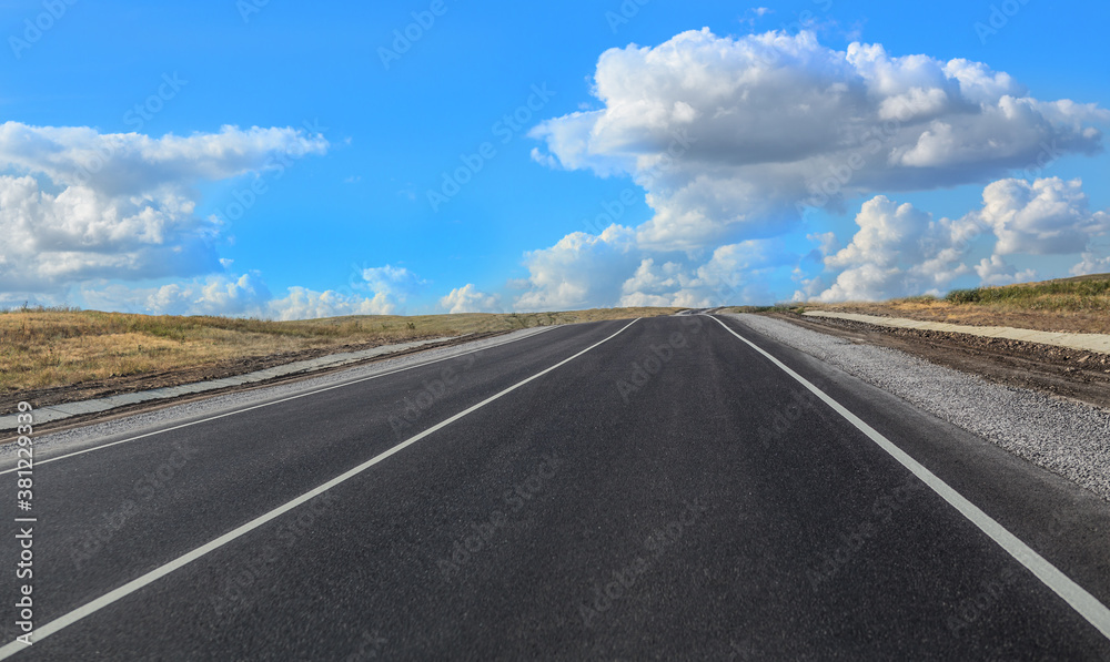 Empty suburban highway under blue sky