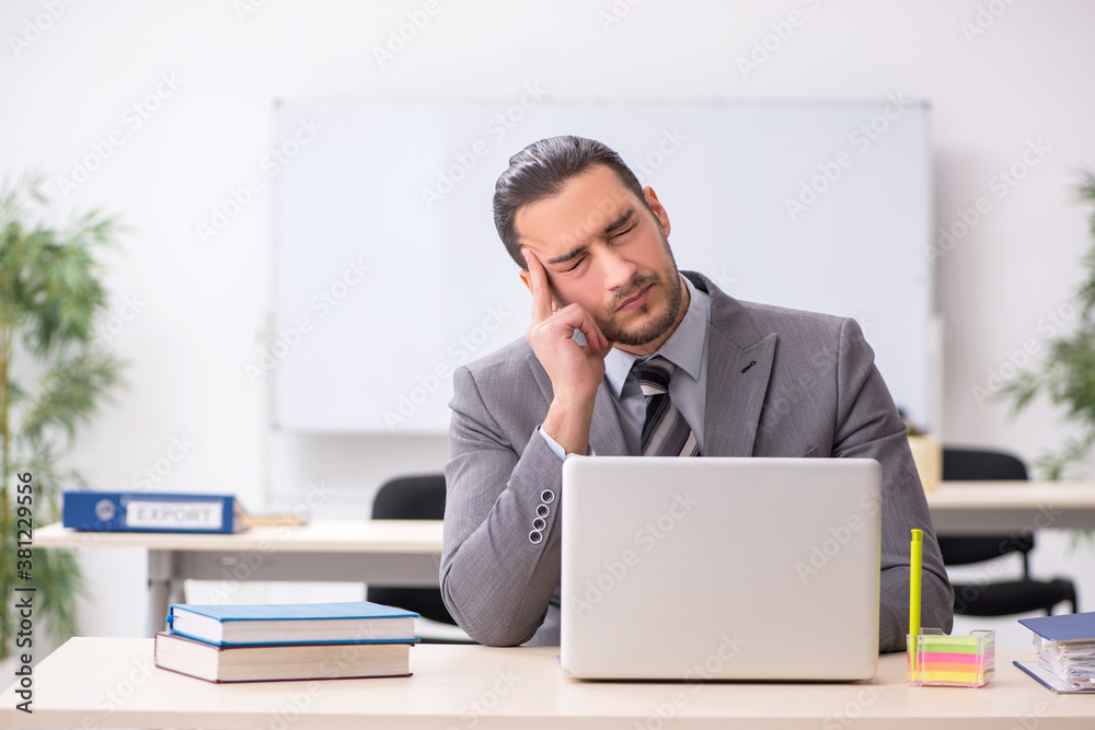 Young male employee working in the office Young male employee working in the office