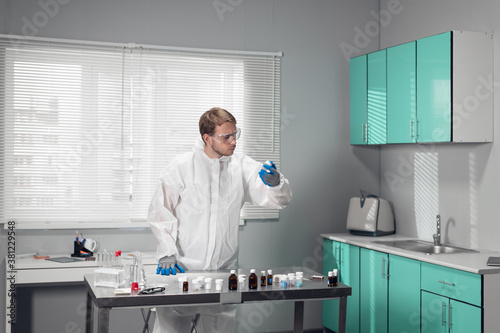 Young chemist  student experimenting in a modern lab.