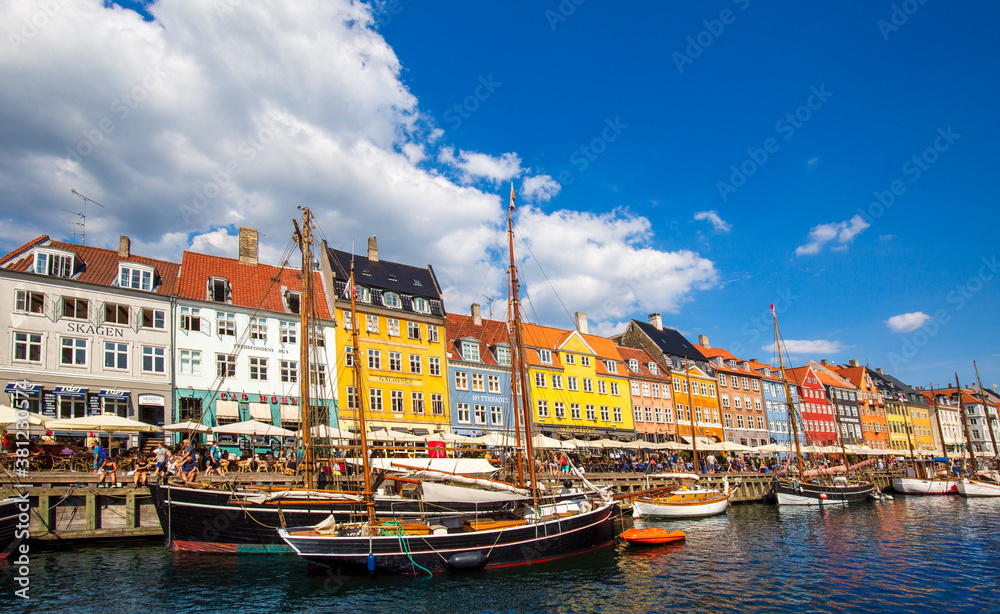 Copenhagen, Denmark-2 August, 2019: Famous Nyhavn (New Harbour) bay in Copenhagen, a historic European waterfront with colorful buildings. A starting point for boat and canal tours