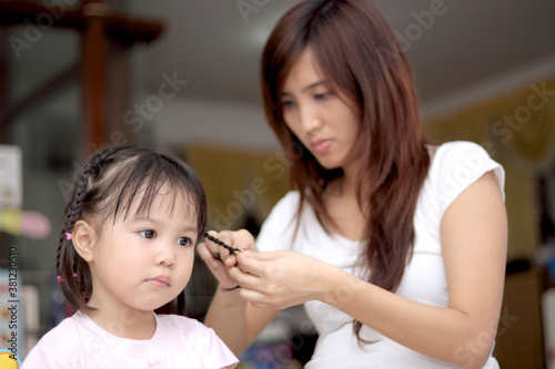 Mother Braid The Hair Of Her Daughter