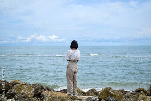 A woman standing by the sea