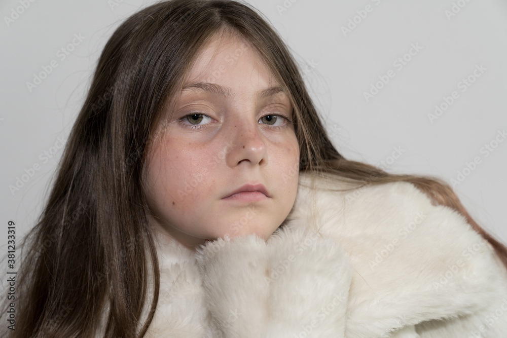 Beautiful Caucasian Young blonde Gir with green eyes wearing a white fake fur winter coat
Beautiful Caucasian Young blonde Gir with green eyes wearing a white fake fur winter coat