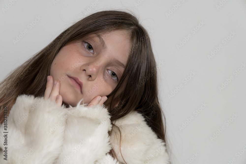 Beautiful Caucasian Young blonde Gir with green eyes wearing a white fake fur winter coat
Beautiful Caucasian Young blonde Gir with green eyes wearing a white fake fur winter coat