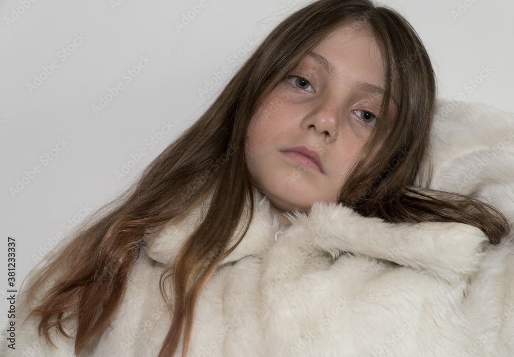 Beautiful Caucasian Young blonde Gir with green eyes wearing a white fake fur winter coat
Beautiful Caucasian Young blonde Gir with green eyes wearing a white fake fur winter coat
