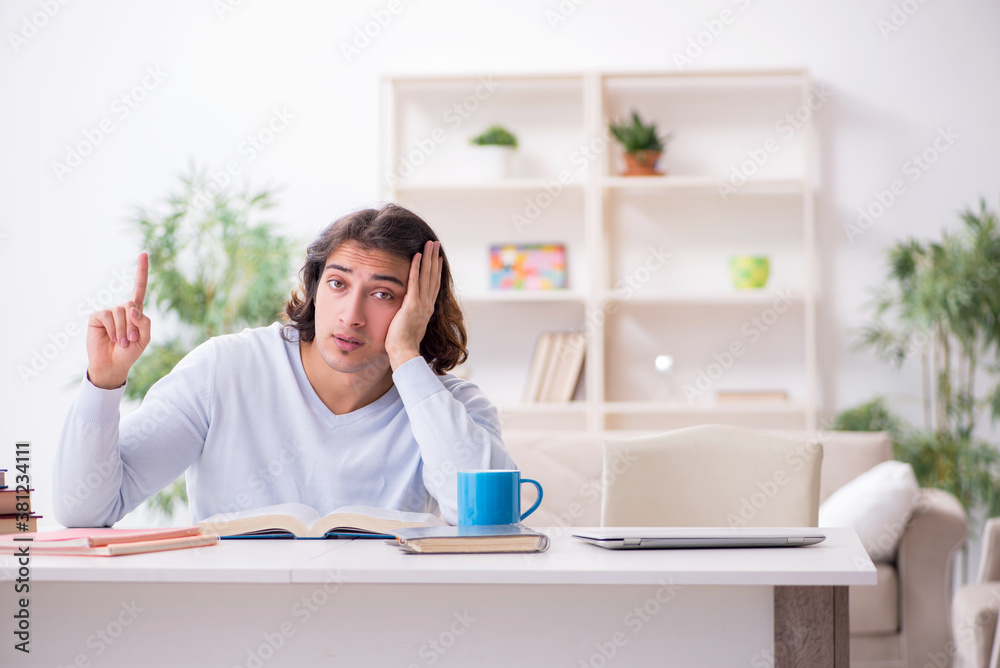 Young male student preparing for exams at home Young male student preparing for exams at home