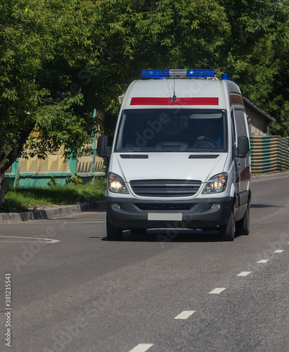 Ambulance car moves along street