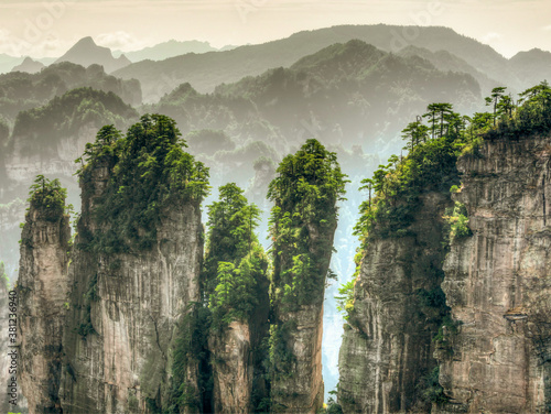 Photo of surreal pillar-like peaks rising tall in Zhangjiajie National Park, China photo
