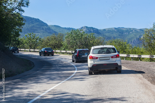 Cars move along a winding road in the mountains