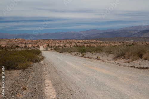 Road trip. Traveling along the dirt road across the arid desert  canyon and mountains. 