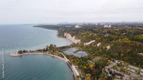 Aerial Panoramic Landscape Image of a Coastline in Toronto with beautiful park and skyline and nature view during fall with autumn colours during dawn