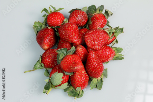 a pile of strawberries with hight key photography technique.