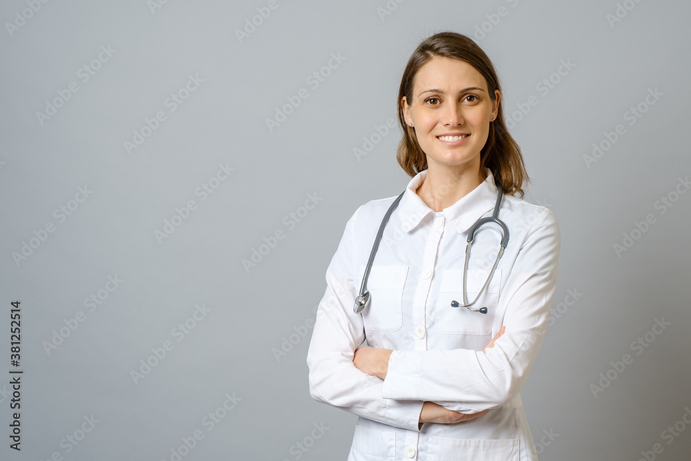Smiling female doctor in lab coat with arms crossed Smiling female doctor in lab coat with arms crossed