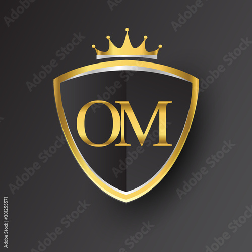 Initial logo letter OM with shield and crown Icon golden color isolated on black background, logotype design for company identity.