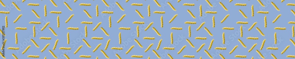 Fusilli pasta random flat lay on blue background without shadow. can be used as raw pasta background, poster, banner not pattern. Fusilli pasta random flat lay on blue background without shadow. can be used as raw pasta background, poster, banner not pattern.