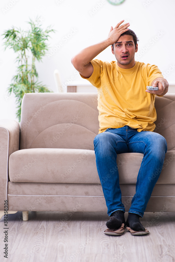 Young man watching tv at home Young man watching tv at home