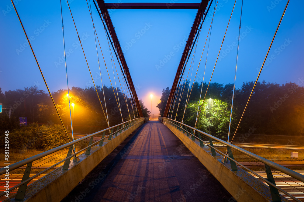 Obraz premium Bridge over freeway in the early morning with fog