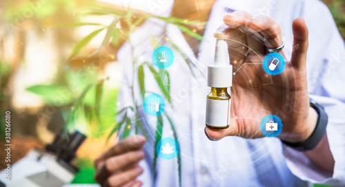 Medical healthcare scientist outdoor holding extraction bottle with cannabis plant purified researching for mediational usage herbal benefits for biological mental disease, man lab coat graphical icon photo