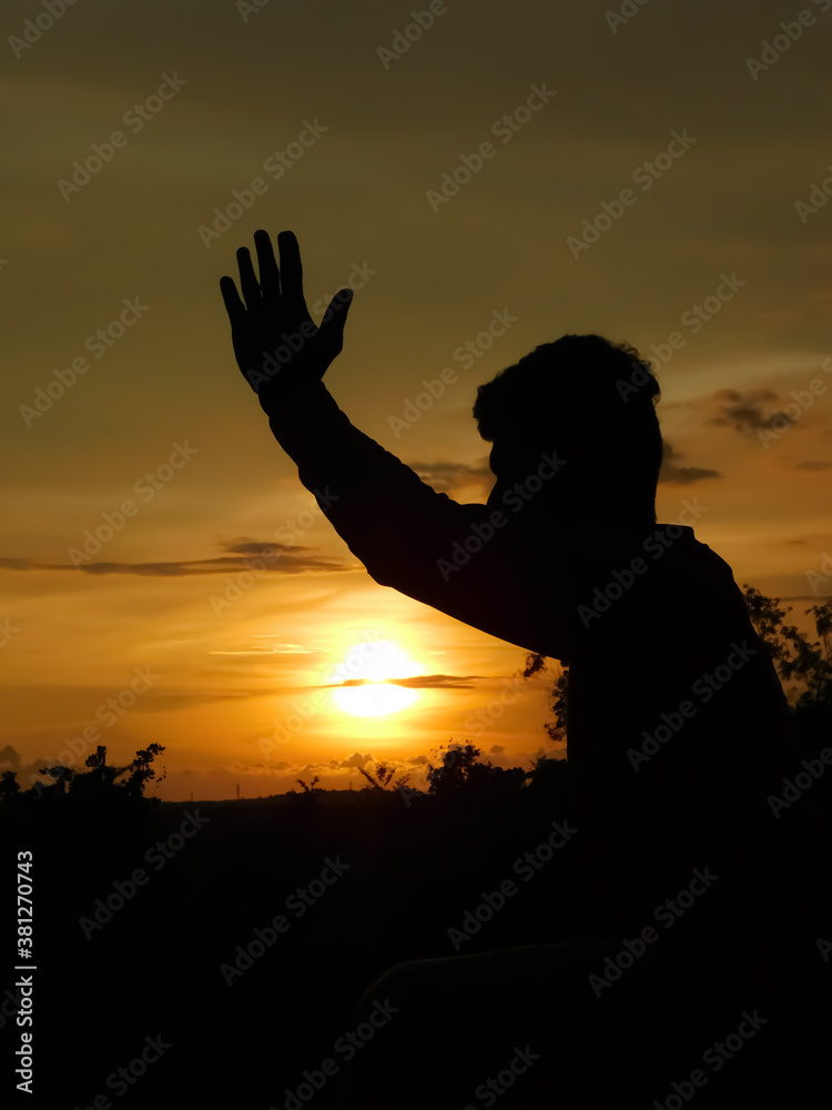 View of sunset and shadow of a man doing yoga