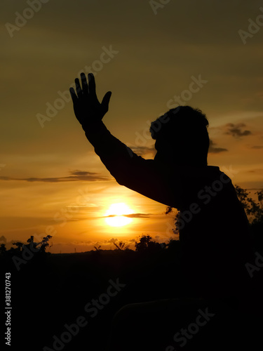 View of sunset and shadow of a man doing yoga
