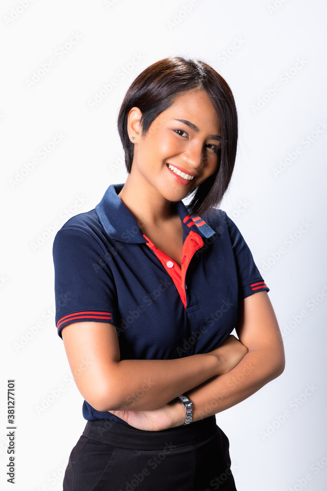 Portrait of a smiling asian woman standing with arms folded and looking at camera isolated over white background Portrait of a smiling asian woman standing with arms folded and looking at camera isolated over white background