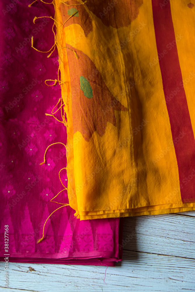 Close up of red and yellow cotton sari on a background. 