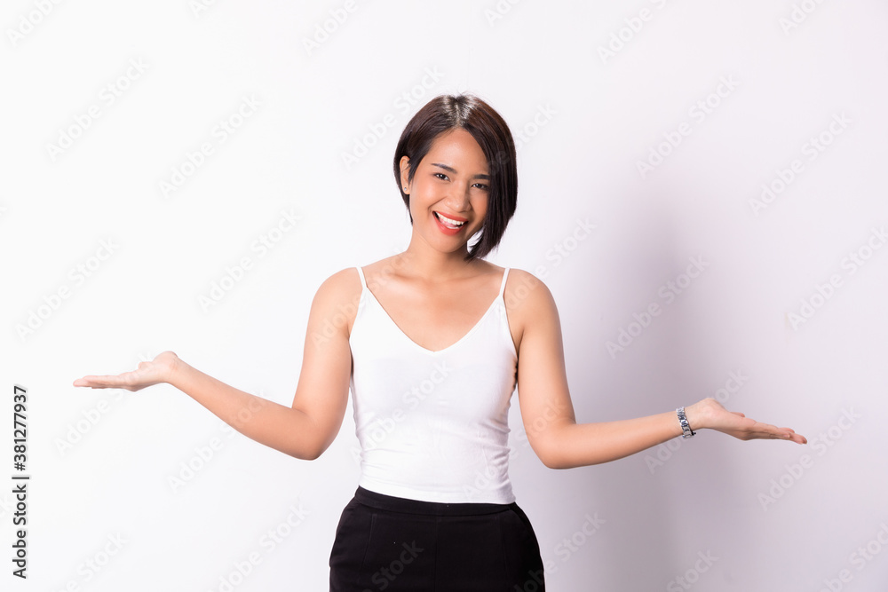 Woman with both her empty palms extended sideways presenting copy-space. Quizzical expression as she indicates that there is a choice or alternative, with copy space for the placement of your products Woman with both her empty palms extended sideways presenting copy-space. Quizzical expression as she indicates that there is a choice or alternative, with copy space for the placement of your products