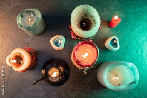 Magic candles on the stone flat lay background.