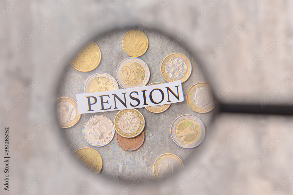 Word PENSION with coins visible through magnifier, closeup. Concept of pension Word PENSION with coins visible through magnifier, closeup. Concept of pension