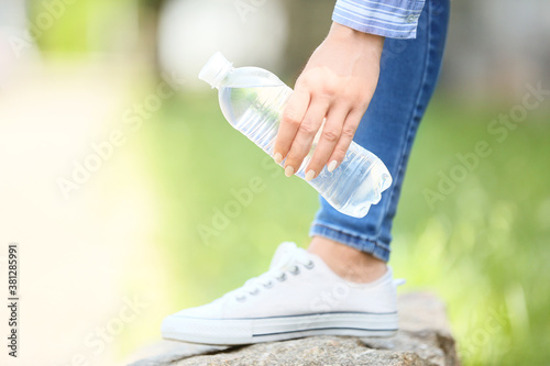 Woman with bottle of water outdoors