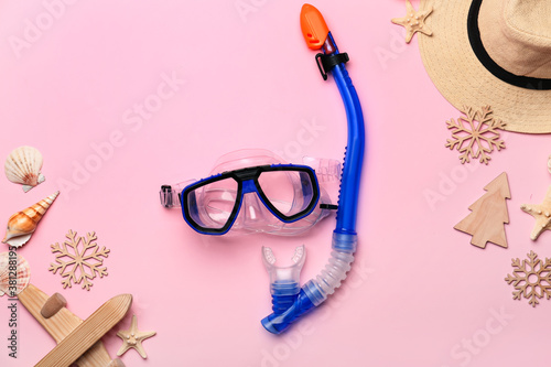 Composition with Christmas decor, snorkeling mask and tube on color background