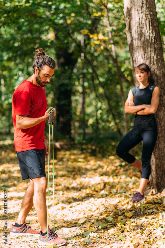 Fototapeta premium Friends Exercising with Elastic Resistance Bands