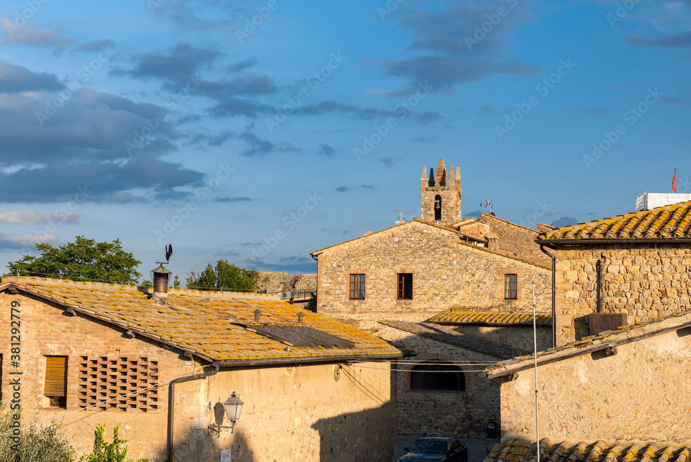 Stone medieval houses in the small town of Monteriggioni in Tuscany, Italy at sunset