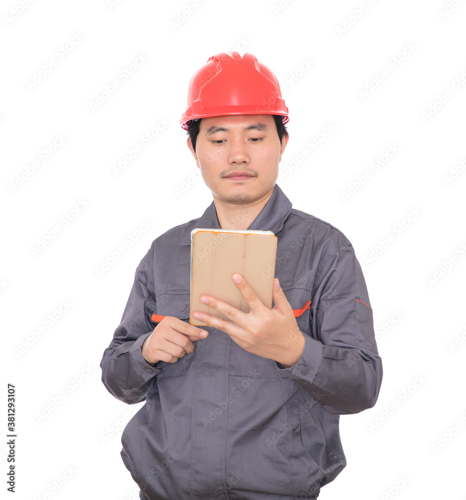 Peasant worker wearing red hard hat holding tablet in hand in front of white background Peasant worker wearing red hard hat holding tablet in hand in front of white background