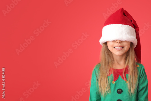 Funny little girl dressed as elf on color background © Pixel-Shot