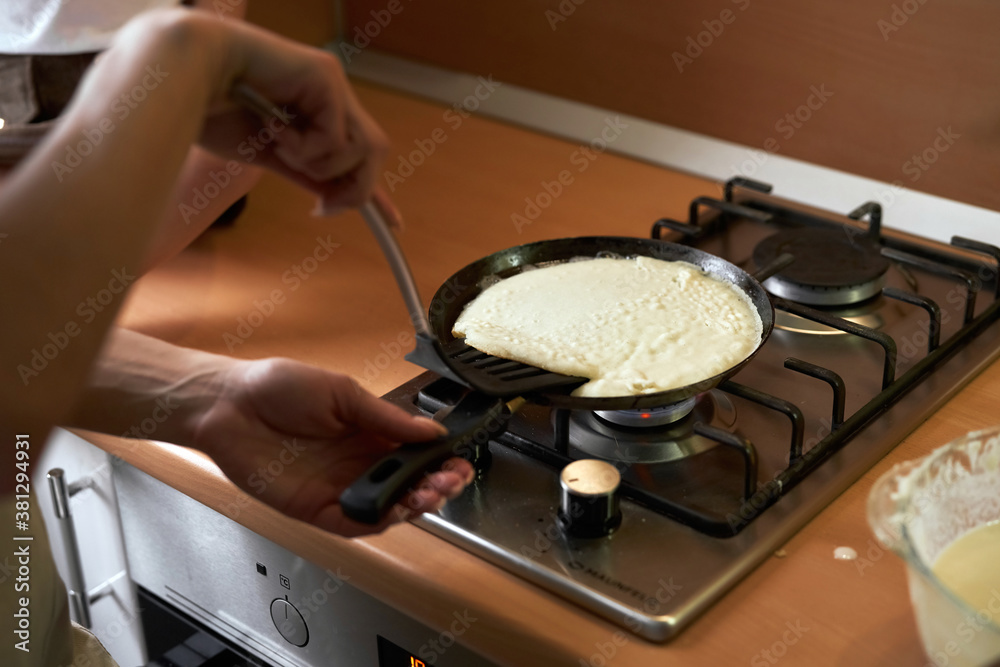 happy mother baking with little daughter in apron and cook hat working with flour , bowl and spoon preparing dough teaching the kid baking and having fun together. happy mother baking with little daughter in apron and cook hat working with flour , bowl and spoon preparing dough teaching the kid baking and having fun together.