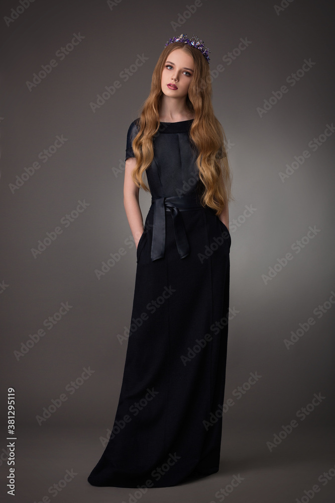 Fototapeta premium beautiful teen blonde girl with exquisite makeup in a stylish black dress