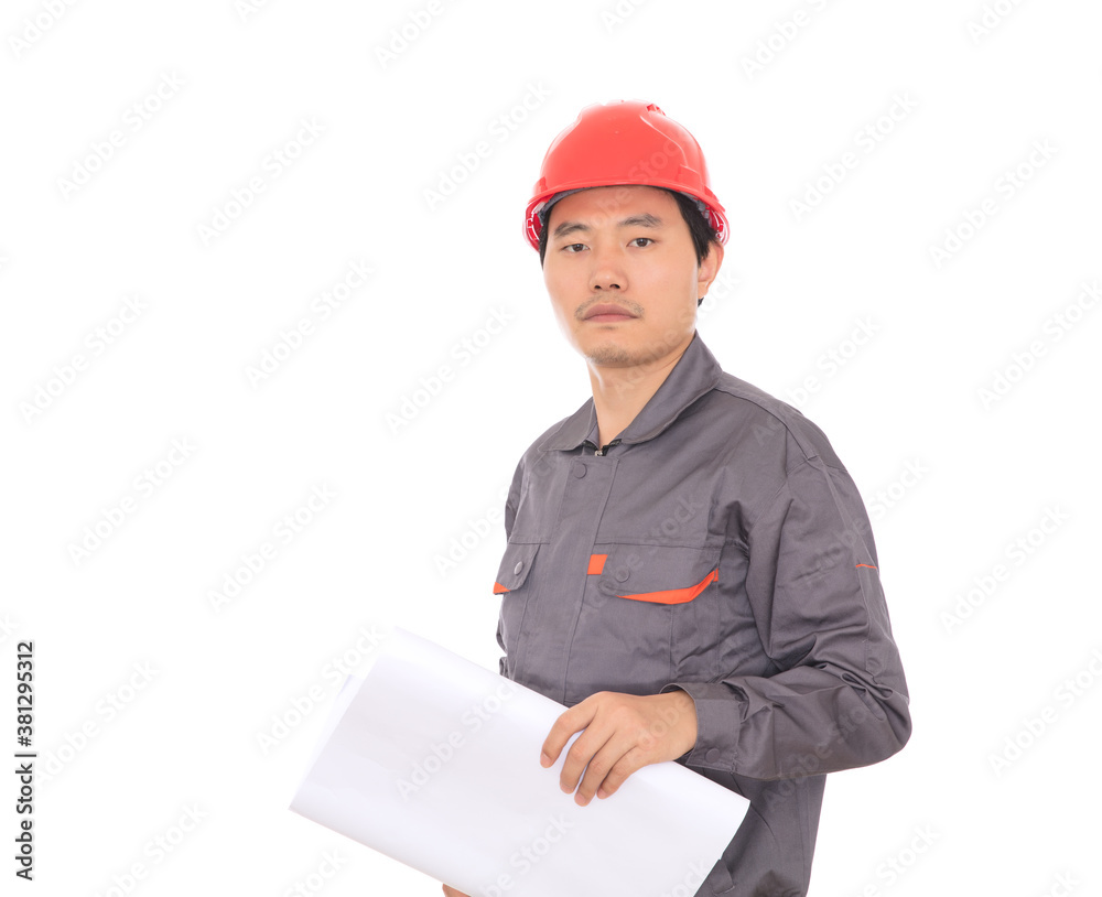 In front of white background a worker holding engineering drawings wearing a red hard hat looking at the camera In front of white background a worker holding engineering drawings wearing a red hard hat looking at the camera