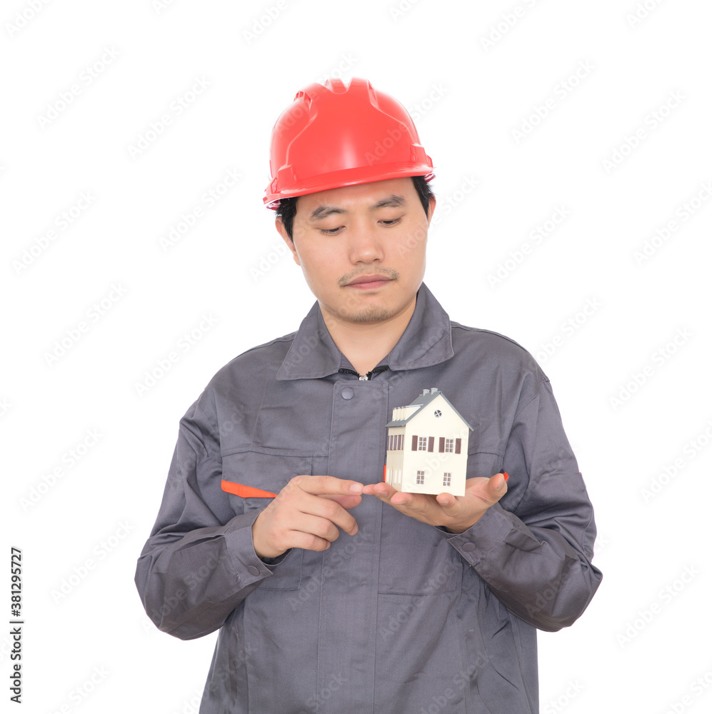 Architect wearing red hard hat viewing small house model in hand Architect wearing red hard hat viewing small house model in hand