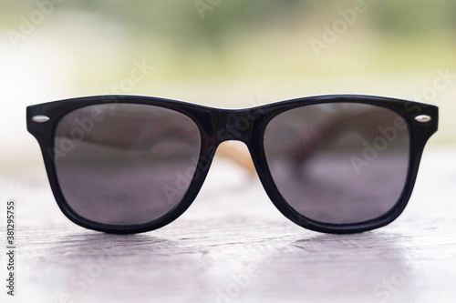 Creative concept about poor vision. Landscape focused in glasses lenses over the photo blurred