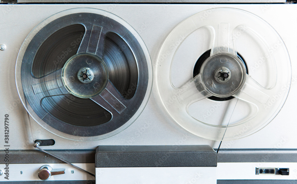 Stereo tape deck recorder player with reels on background. Stereo tape deck recorder player with reels on background.
