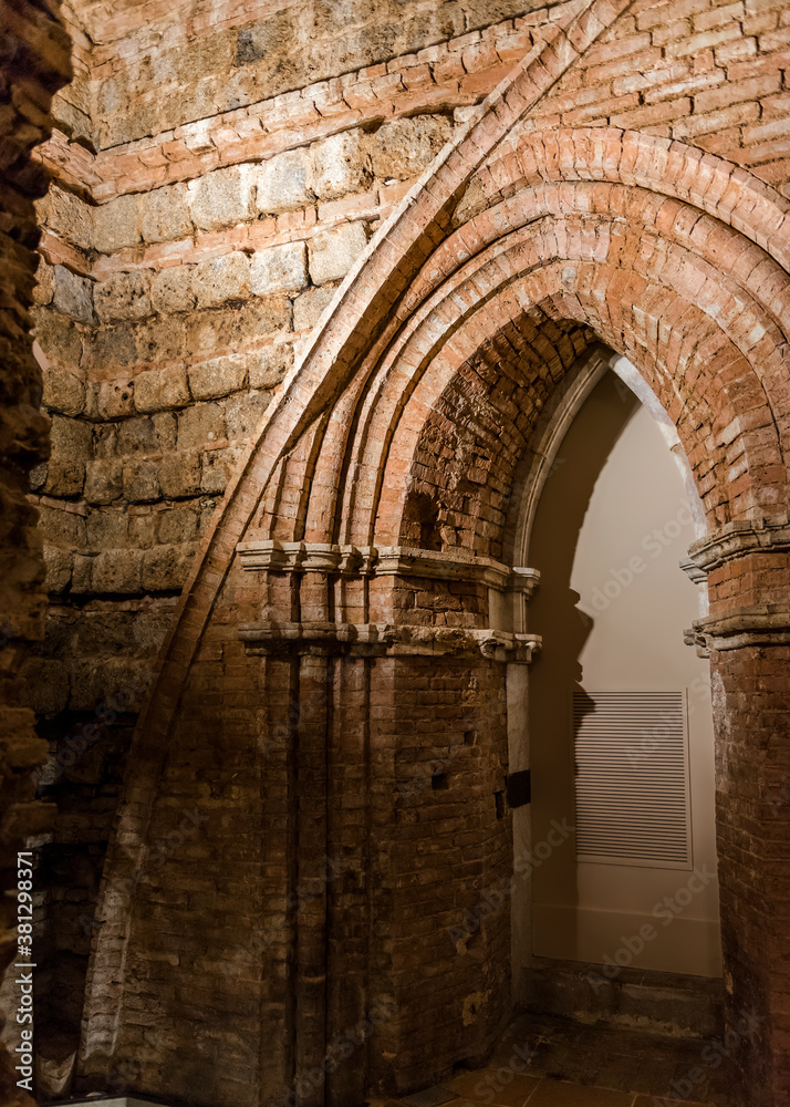 Fragment of brick masonry and arch of the 13th century on the lower floors under the church Siena Cathedral (Duomo di Siena) in Siena, Italy