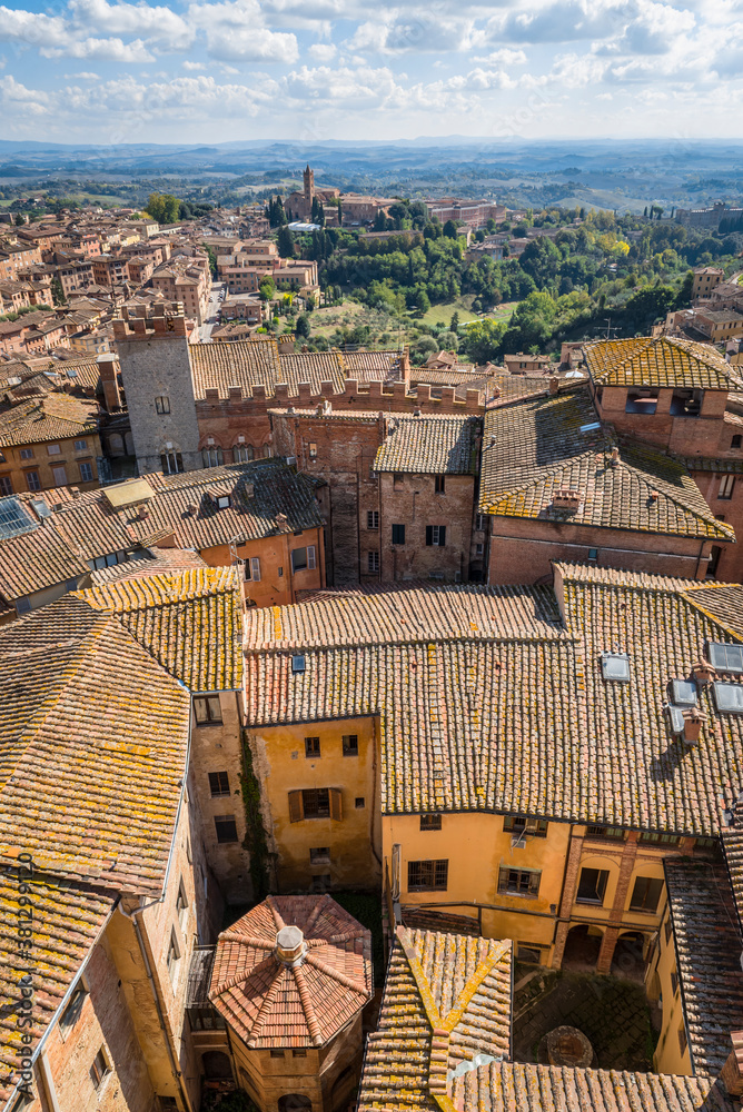 Top view of medieval houses, churches, castles and surroundings of Siena, Italy