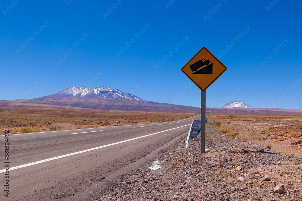 Road with sign on the high altitude plateau (Altiplano) of the Andes in northern Chile
