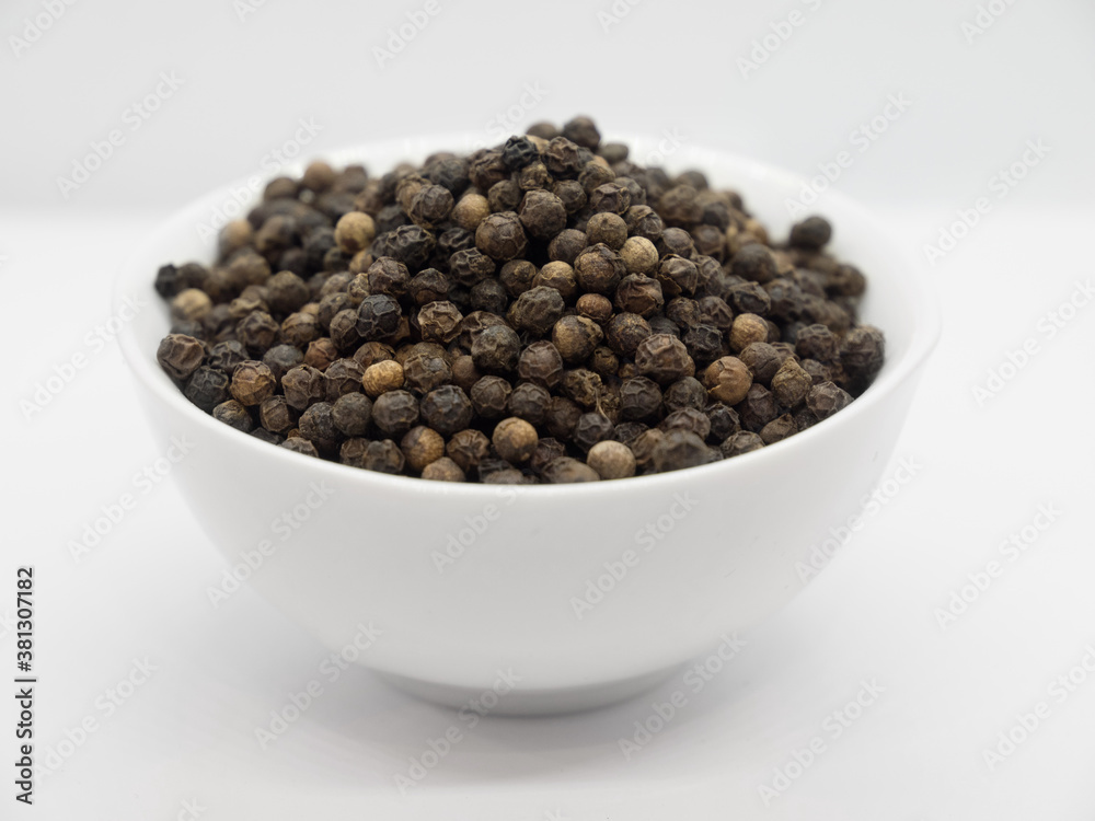 Black pepper, herbs, spices in a white bowl Black pepper, herbs, spices in a white bowl