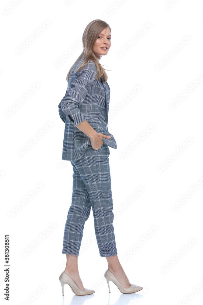 side view of confident businesswoman holding hands in pockets side view of confident businesswoman holding hands in pockets