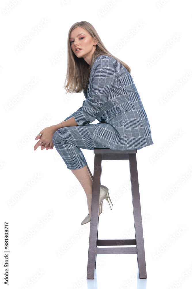sexy young businesswoman holding elbows on knees sexy young businesswoman holding elbows on knees